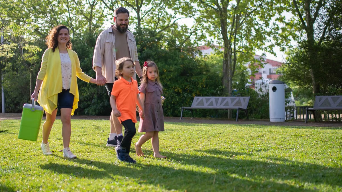 A joyful family with children strolling in a sunny Portuguese park.